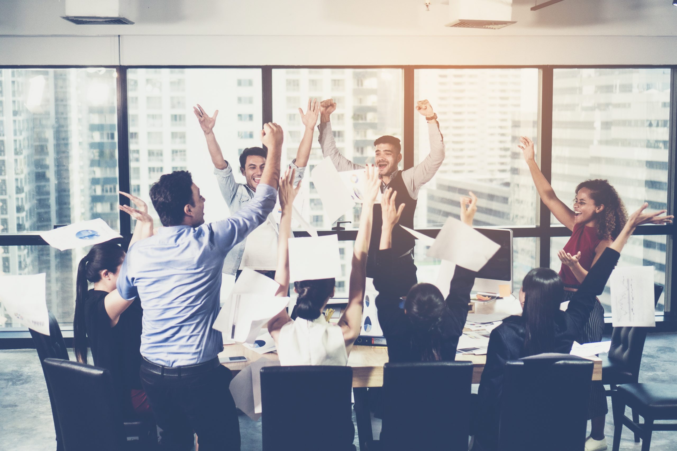 Business team celebrating a triumph with arms up